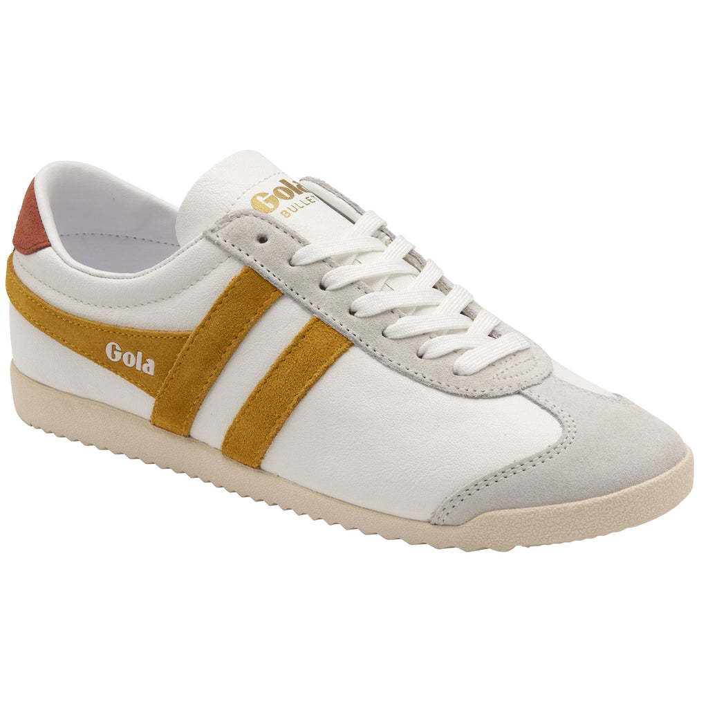 A white Gola Bullet sneaker with gold stripes and a brown heel accent shown from an angle.
