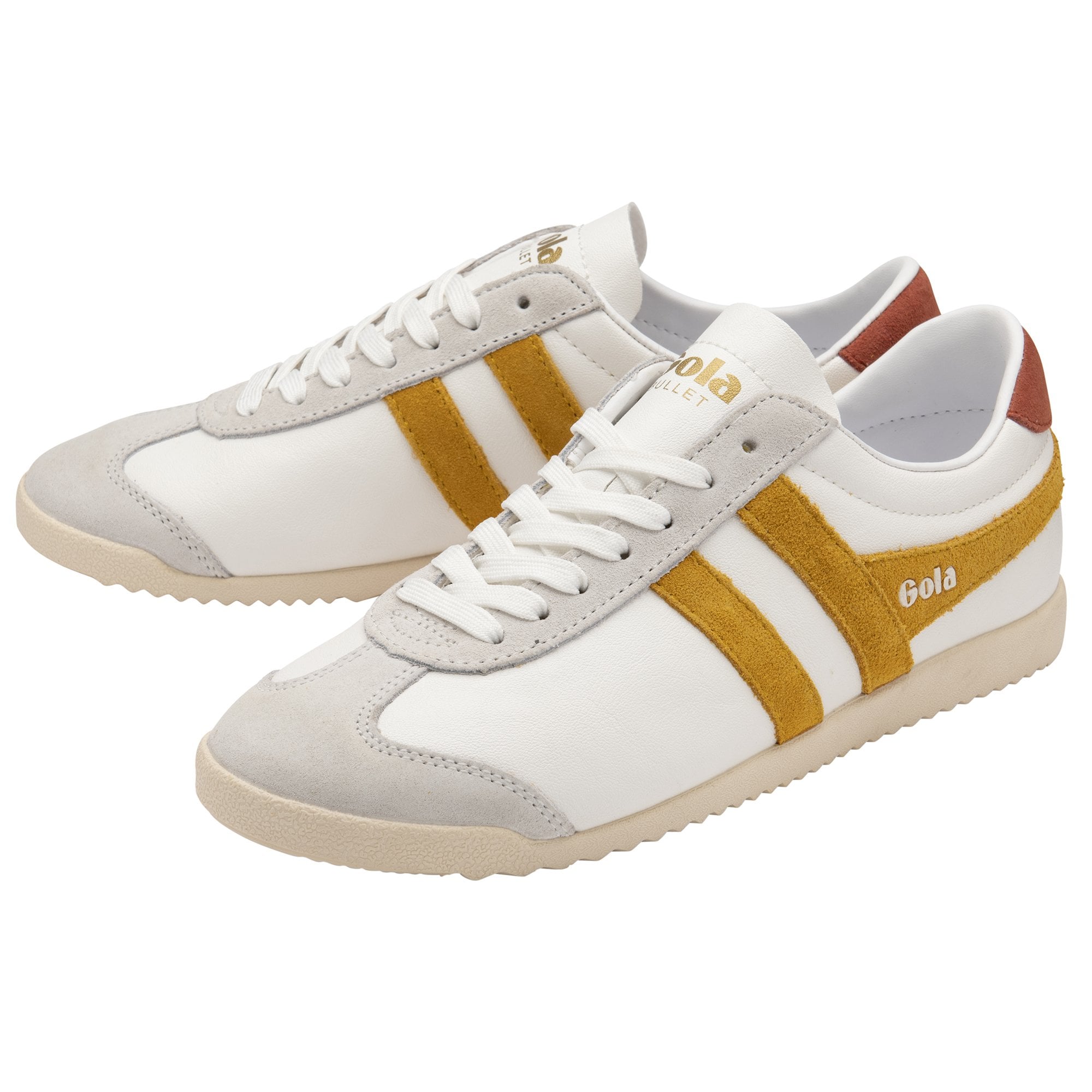 A pair of white Gola Bullet sneakers with gold stripes and brown heel accents.