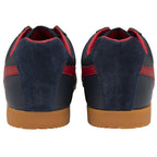 A pair of Gola low-top sneakers in navy with red stripes and gum soles, viewed from the back.