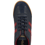 A single Gola low-top sneaker in navy with red stripes and a gum sole, viewed from above.