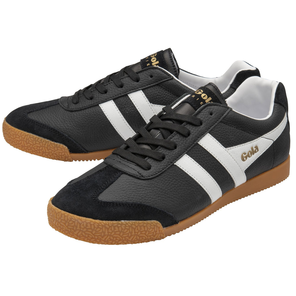 A pair of black Gola men's sneakers with white stripes and gum soles, angled.