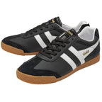 A pair of black Gola men's sneakers with white stripes and gum soles, angled.