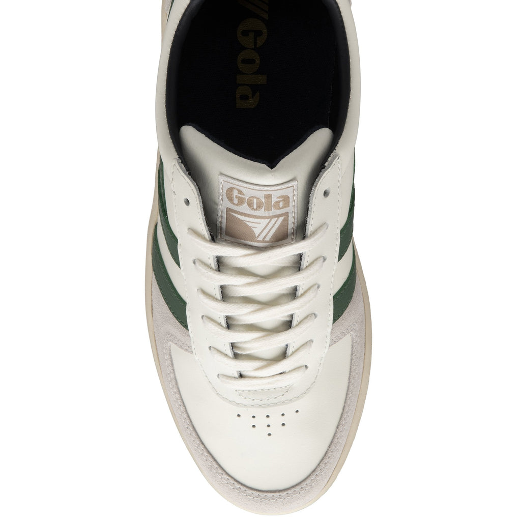 An overhead view of a white and green Gola sneaker with a beige sole.