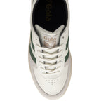 An overhead view of a white and green Gola sneaker with a beige sole.