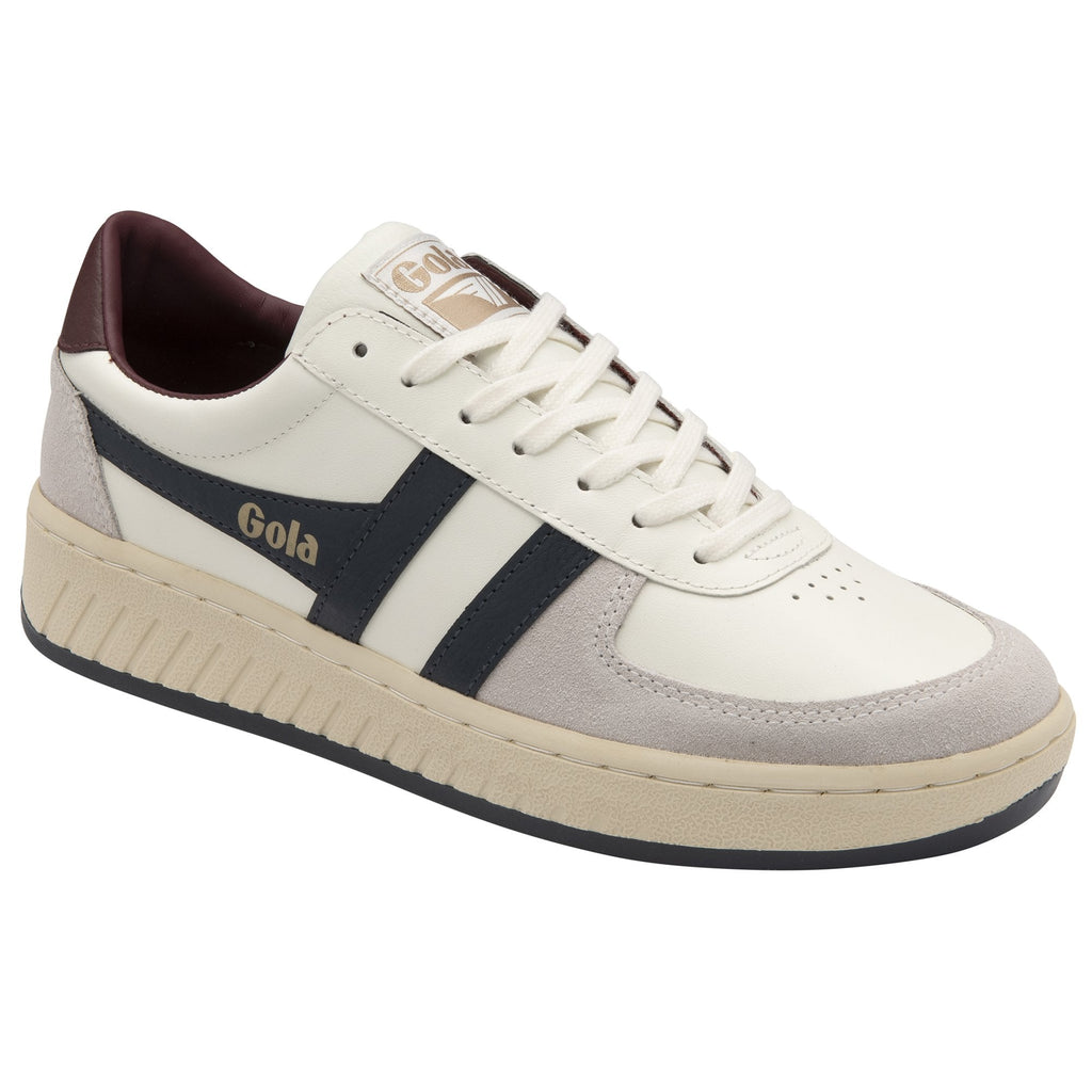 A three-quarter view of a Gola men's sneaker in white and navy with a brown heel.