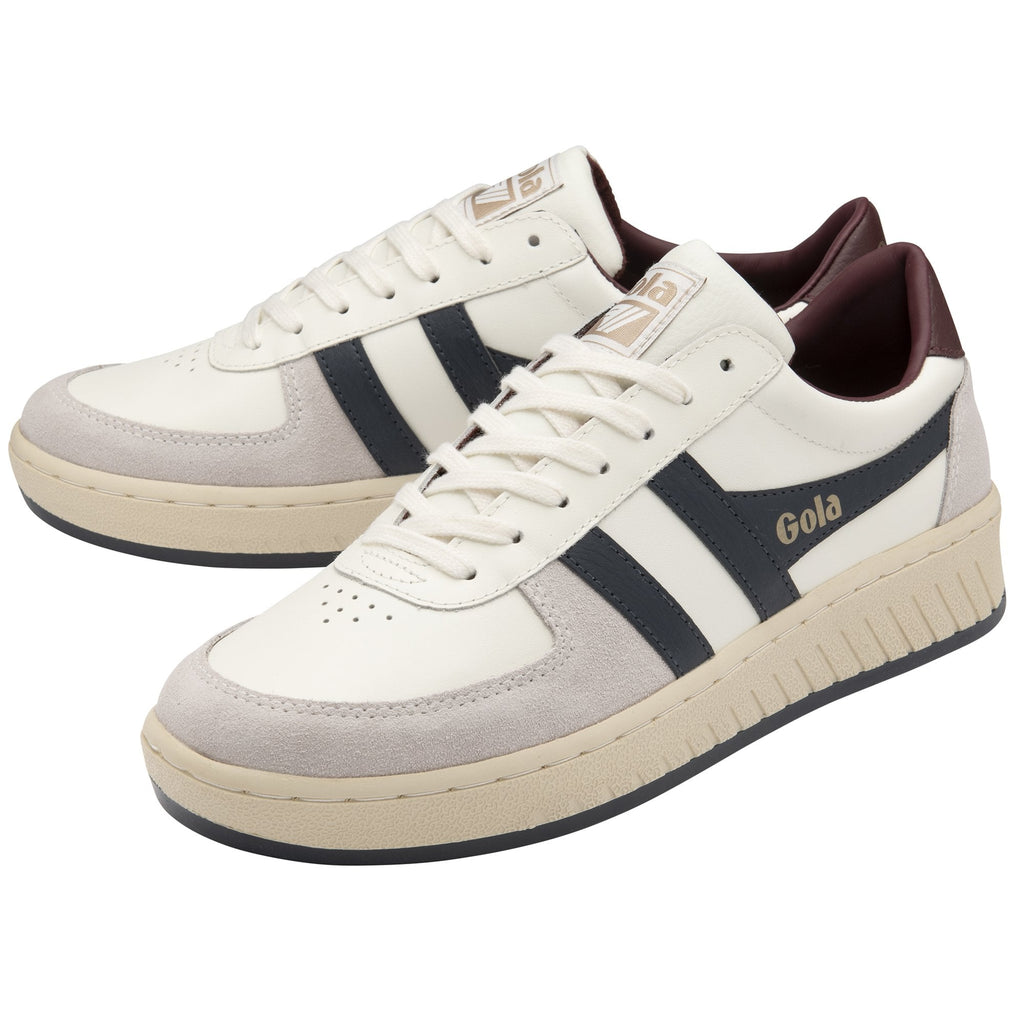 A pair of Gola men's sneakers in white and navy with a brown heel.