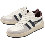 A pair of Gola men's sneakers in white and navy with a brown heel.