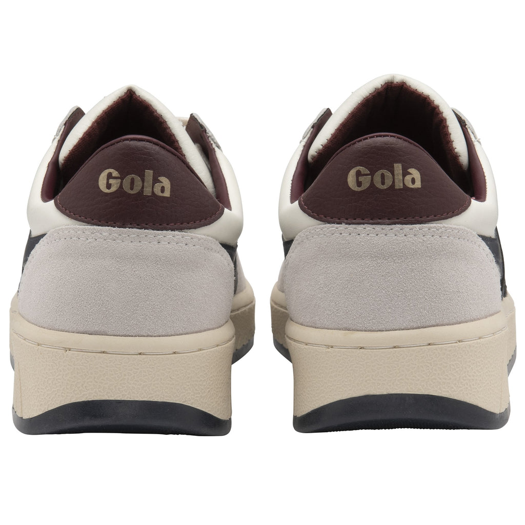 A rear view of a pair of Gola men's sneakers in white, navy, and brown.