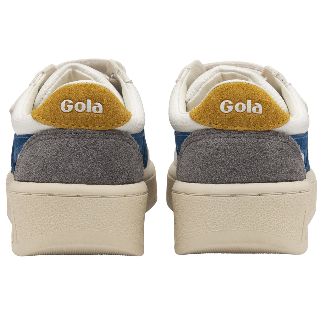 The rear view of two white Gola sneakers, showing yellow heel tabs and beige soles.