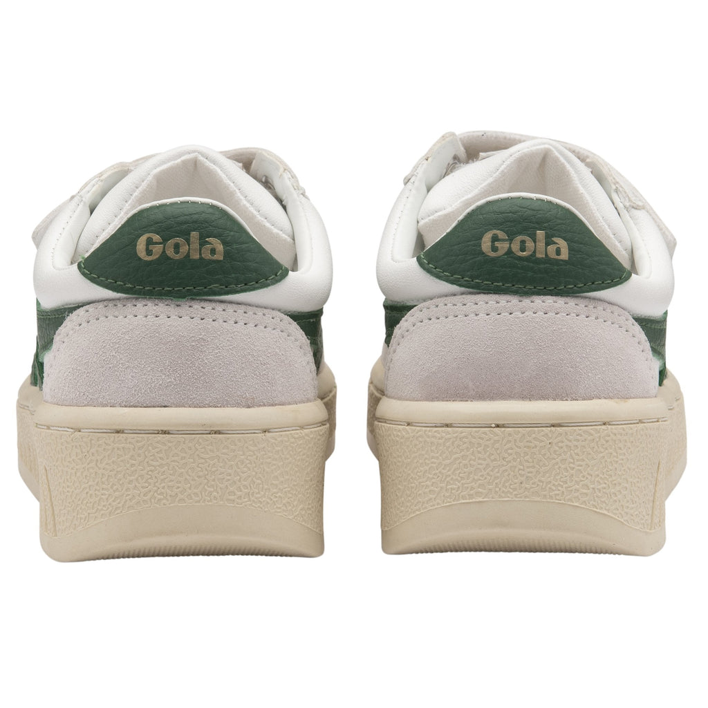 The heels of two white Gola sneakers with green trim.