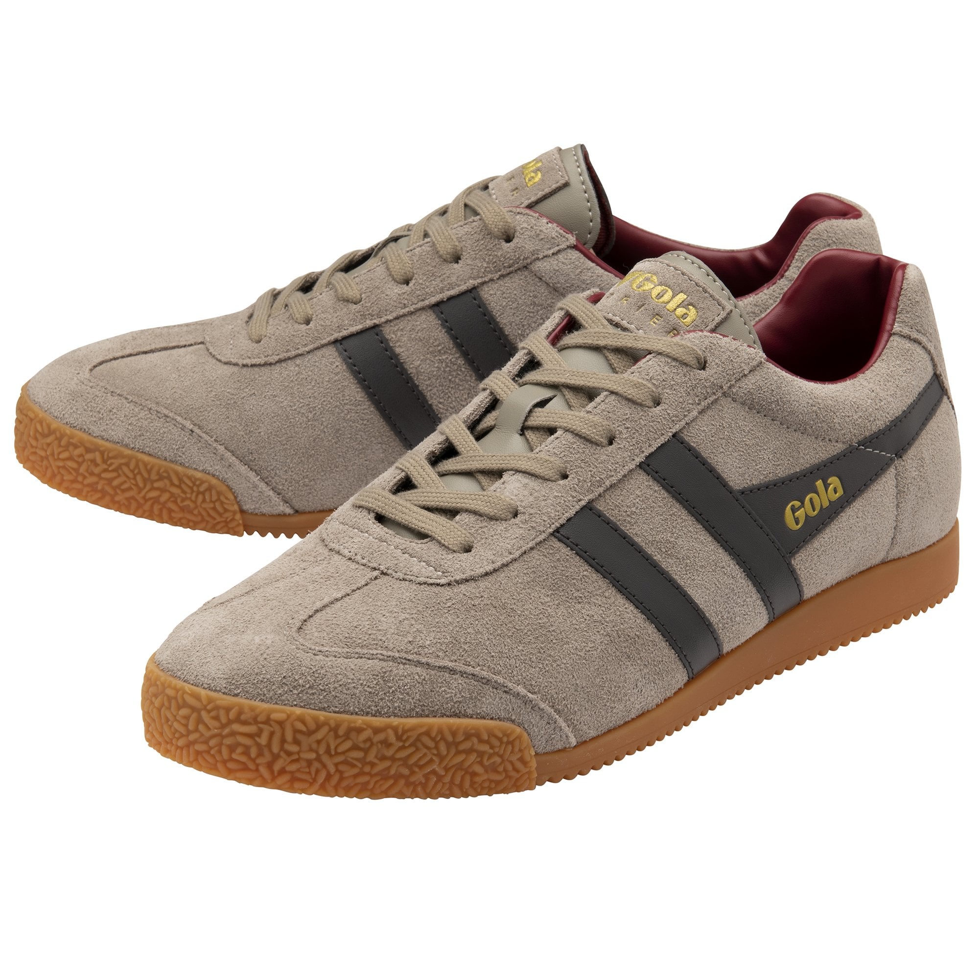 A pair of light brown Gola shoes with dark stripes on their sides.