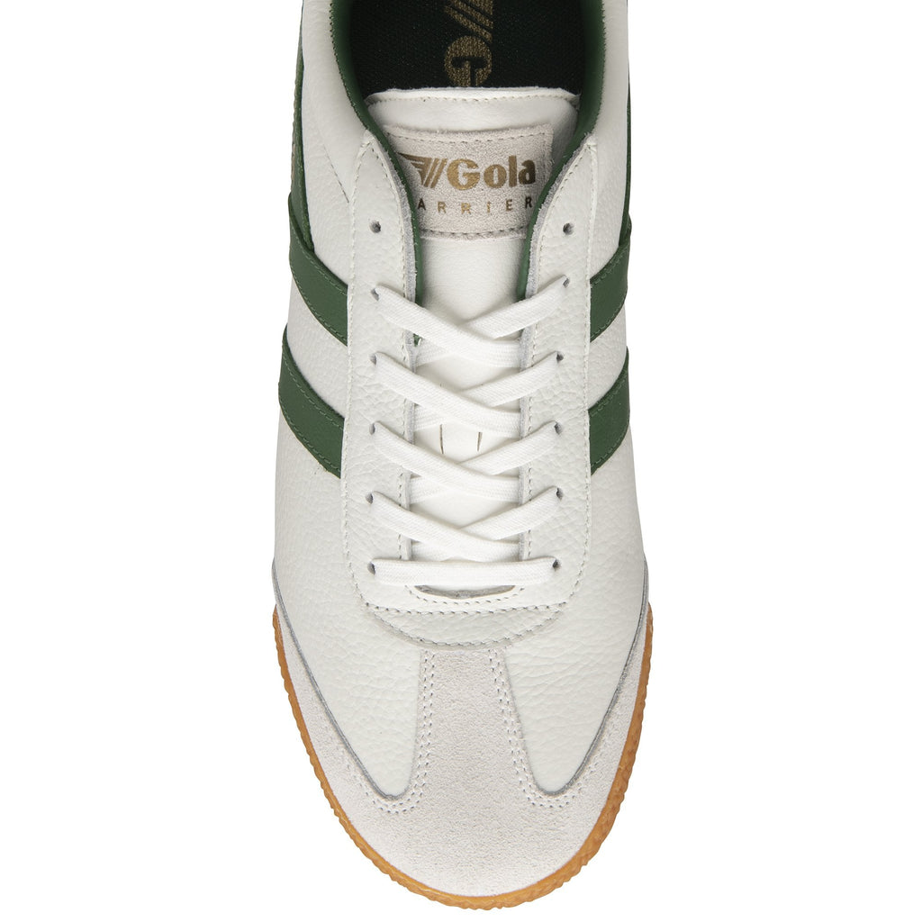 The top-down view of a single white Gola Harrier trainer with green stripes and white laces.