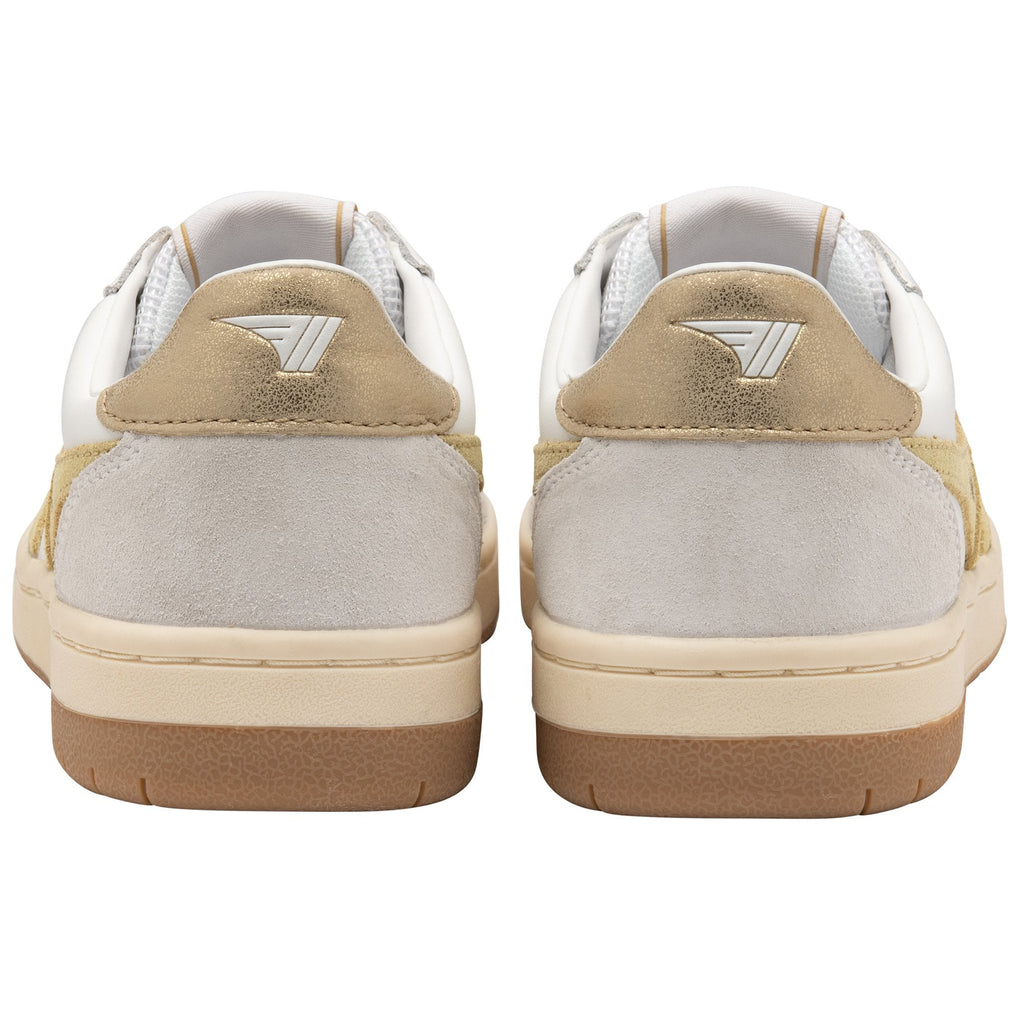 The back view of a pair of white and gold sneakers with a logo on the heel.