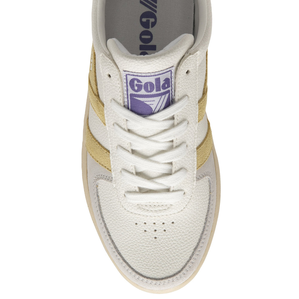 Top view of a Gola sneaker with a white base, gold stripes, and beige sole.