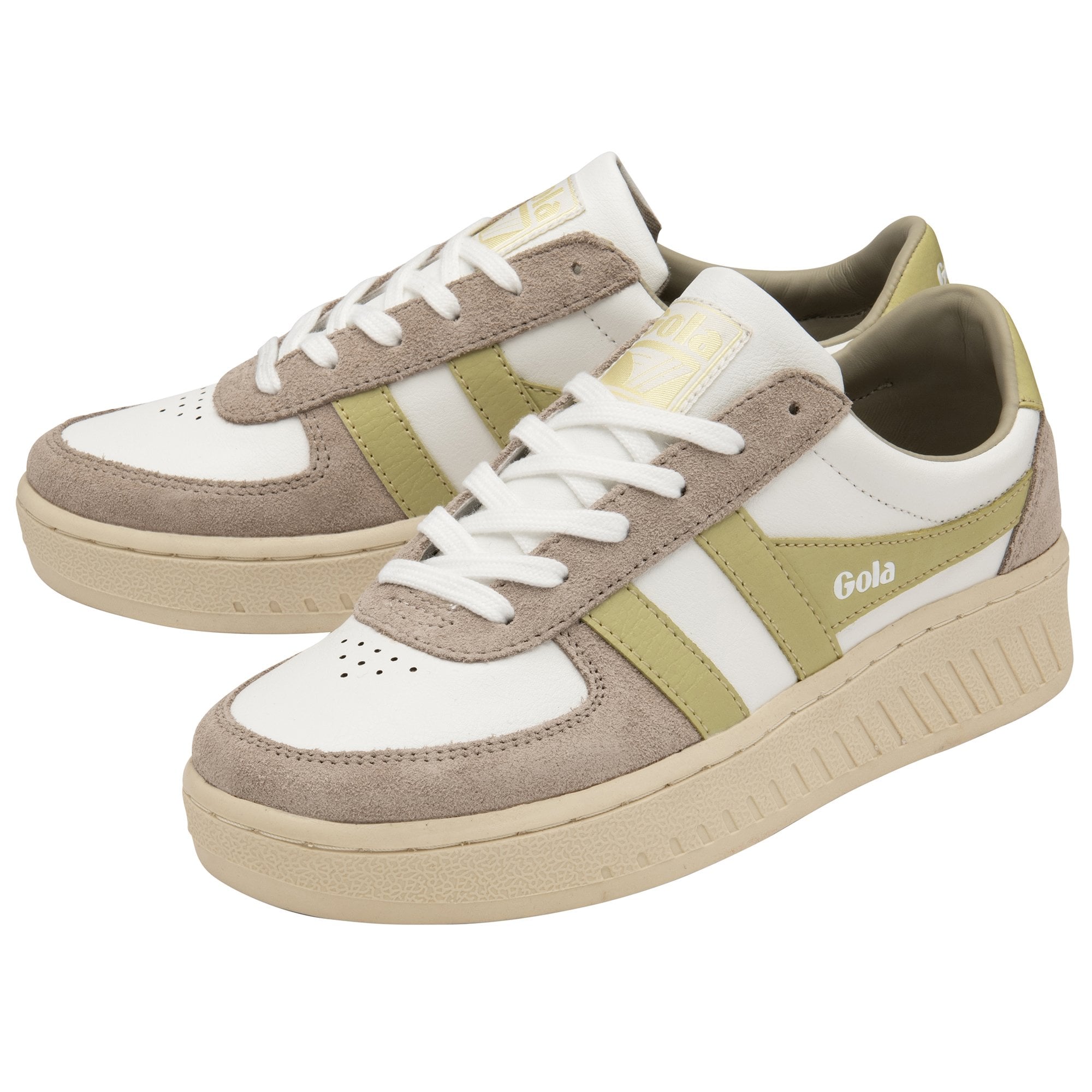 A pair of women's Gola sneakers in off-white and gold with neutral soles.