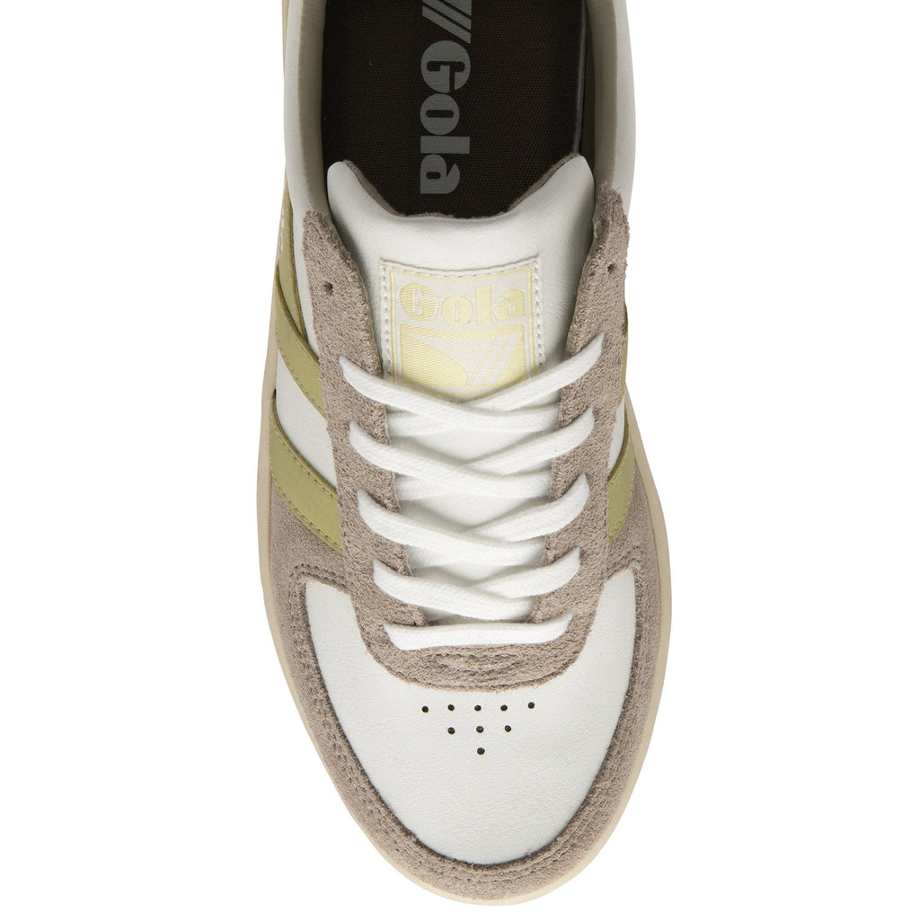 An overhead view of a women's Gola sneaker in off-white and gold with a neutral sole.