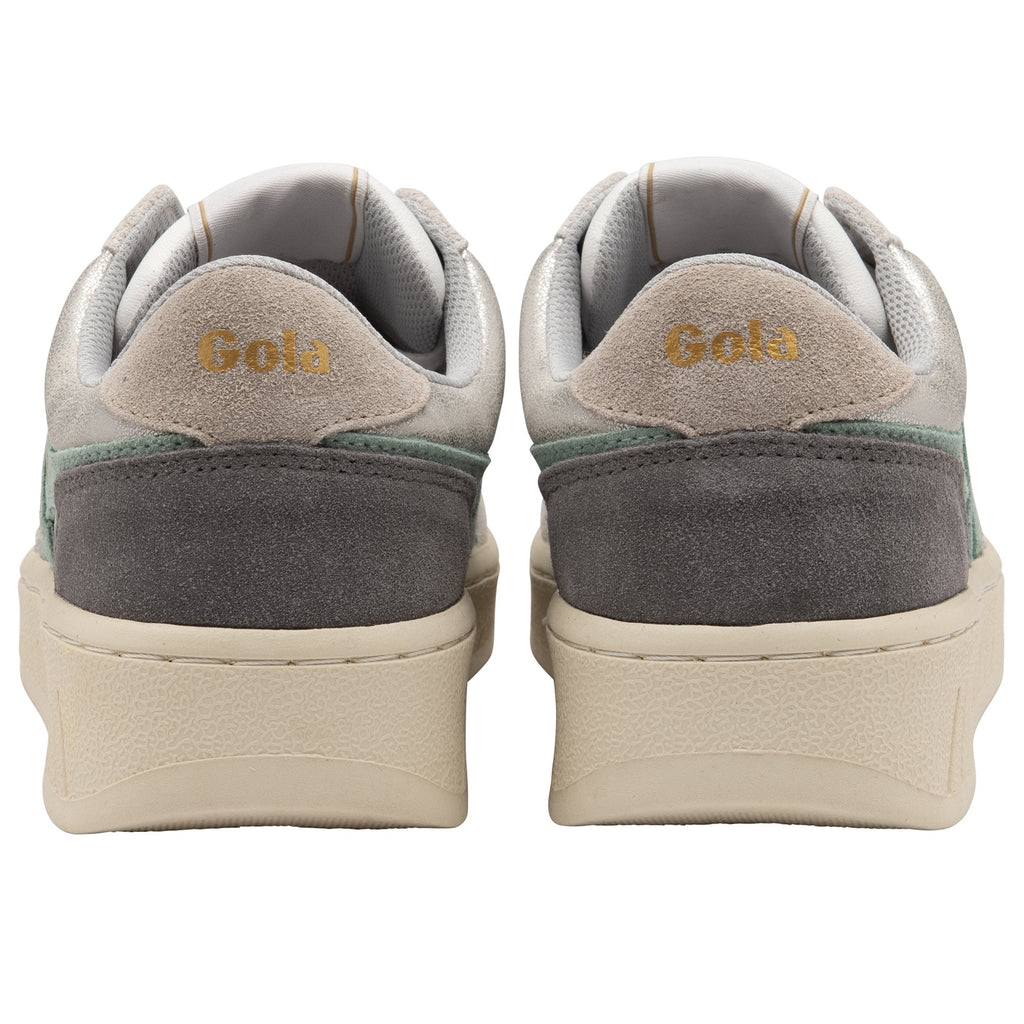 Back view of two women's sneakers with white, cream, tan, and green colors.