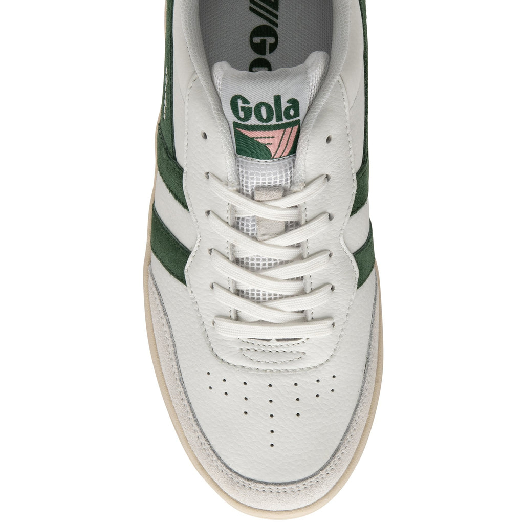 The top-down view of a white sneaker with green stripes and pink detailing.