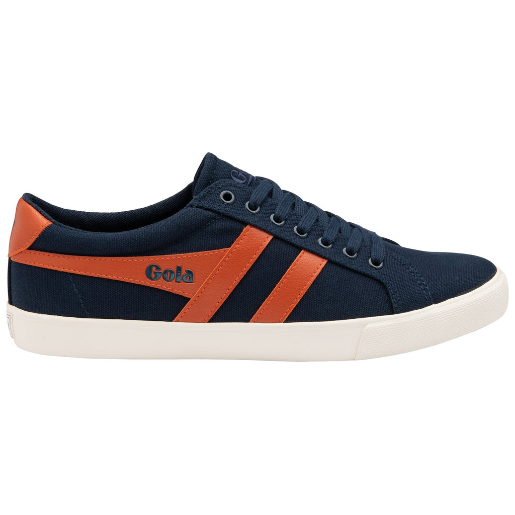 A single Gola low-top sneaker in navy canvas with two orange stripes and a white sole.