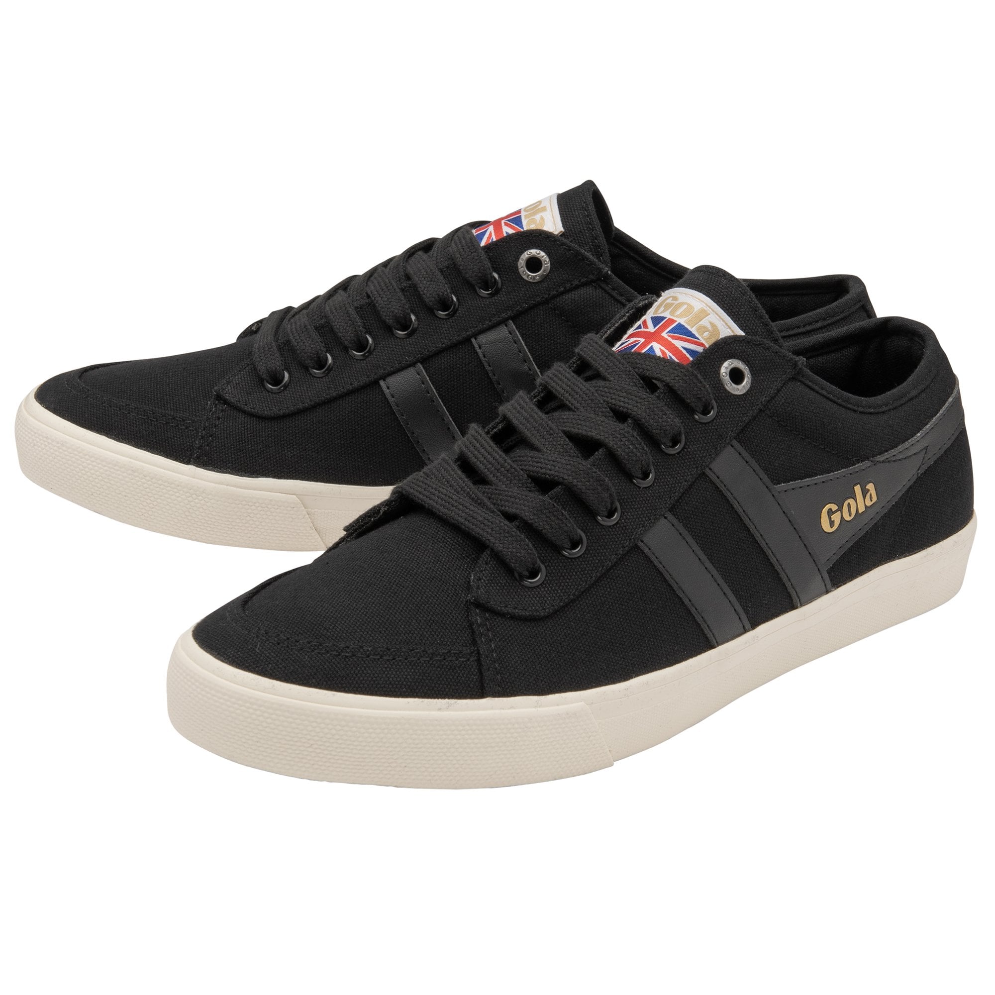 A pair of black canvas sneakers with white soles, gold 'Gola' text, and Union Jack tags.