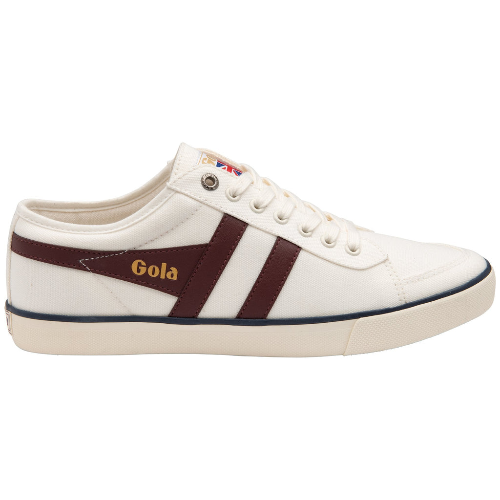 Side profile of a Gola white sneaker with two brown stripes.