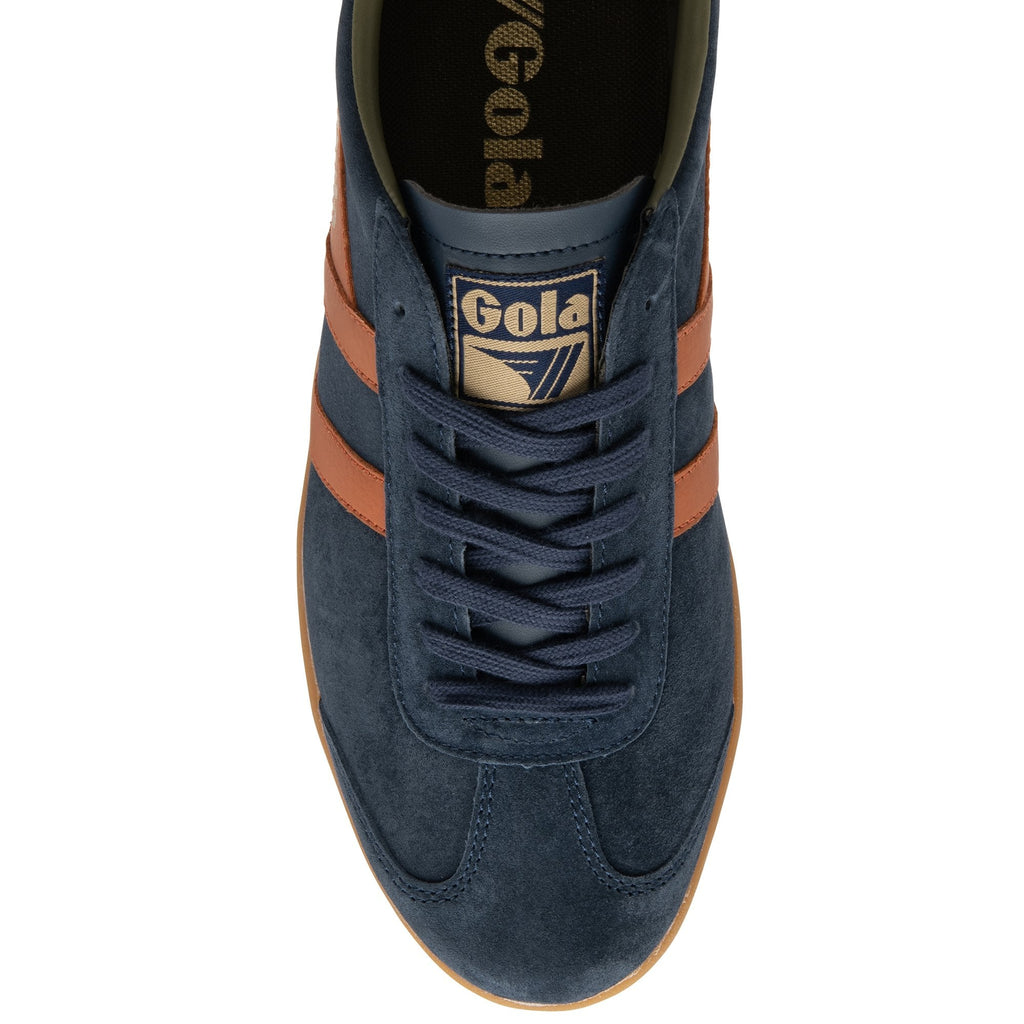 Top down view of a navy blue Gola shoe with orange stripes and a brown sole.