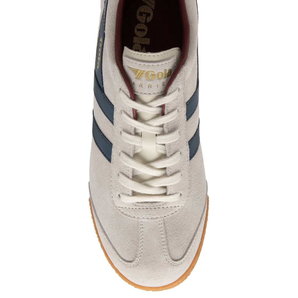 A top-down view of an off-white Gola Harrier trainer with navy stripes and cream laces.