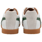 The rear view of a pair of white Gola Harrier trainers with green stripes.