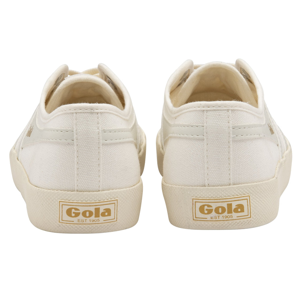 Rear view of two white canvas Gola sneakers, showing the gold logo on the heel.