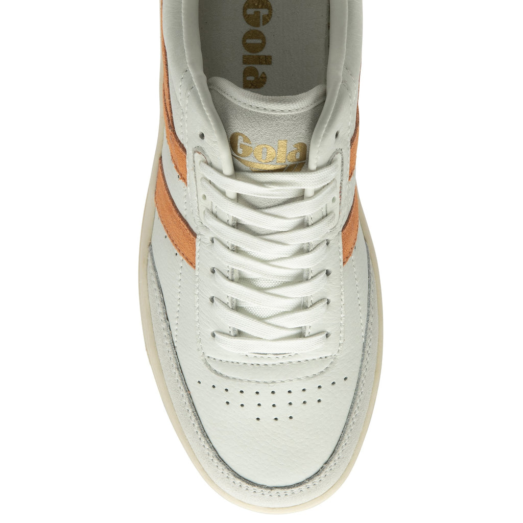 Top-down view of an off-white sneaker with orange stripes and white laces.
