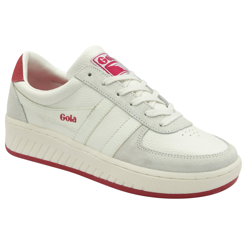 Side view of a white Gola sneaker with pink accents.