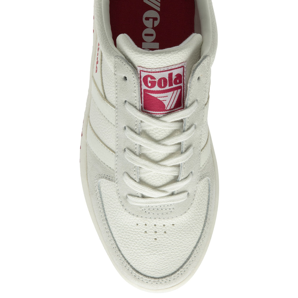 Top-down view of a white Gola sneaker with pink logo on the tongue.