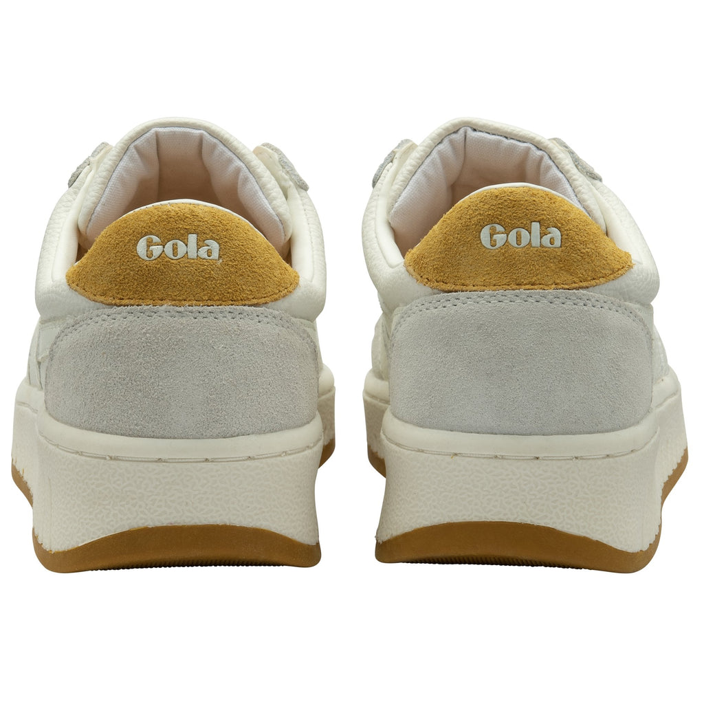 The back view of a pair of Gola sneakers, showing the yellow heel tab.
