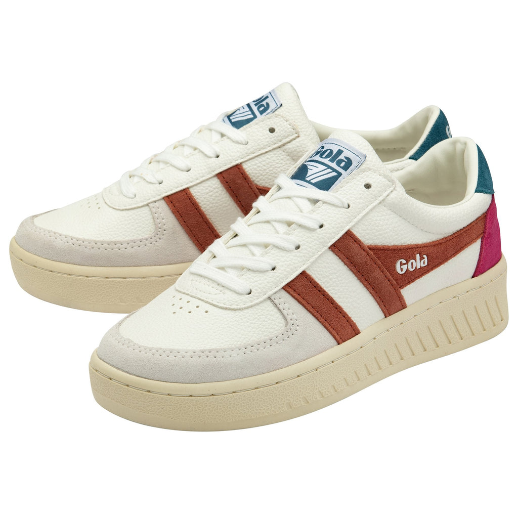 A pair of white Gola sneakers with brown stripes and pink and teal accents.