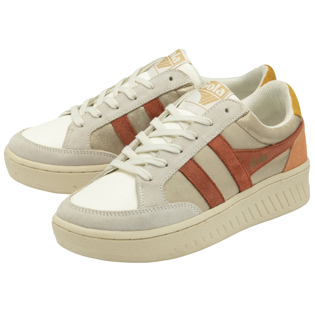 A pair of Gola sneakers with gold, brown, and white colors and an orange heel.