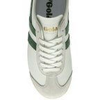 A top-down close-up view of the front of a white Gola Bullet trainer with green stripes.