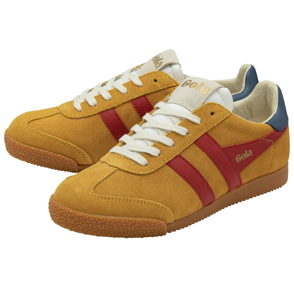 A pair of Gola Harrier trainers in tan, red, and blue at an angle.