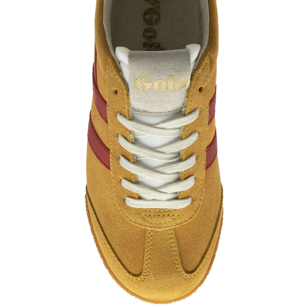 The top-down view of a single Gola Harrier trainer in tan, red, and blue.