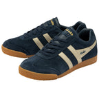 A pair of Gola Harrier trainers in navy with beige stripes on a white background.