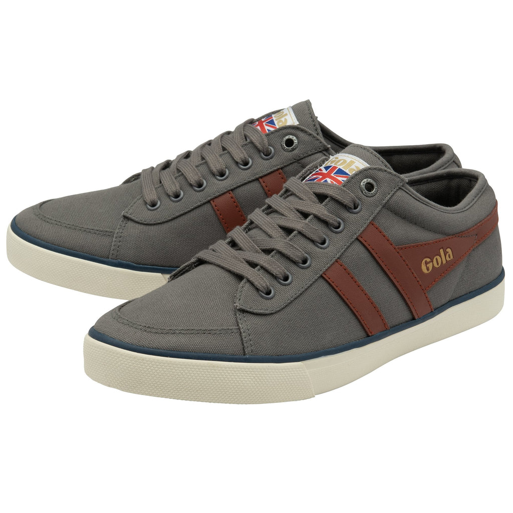A pair of Gola men's Harrier trainers in graphite with a tan wingflash, at an angle.