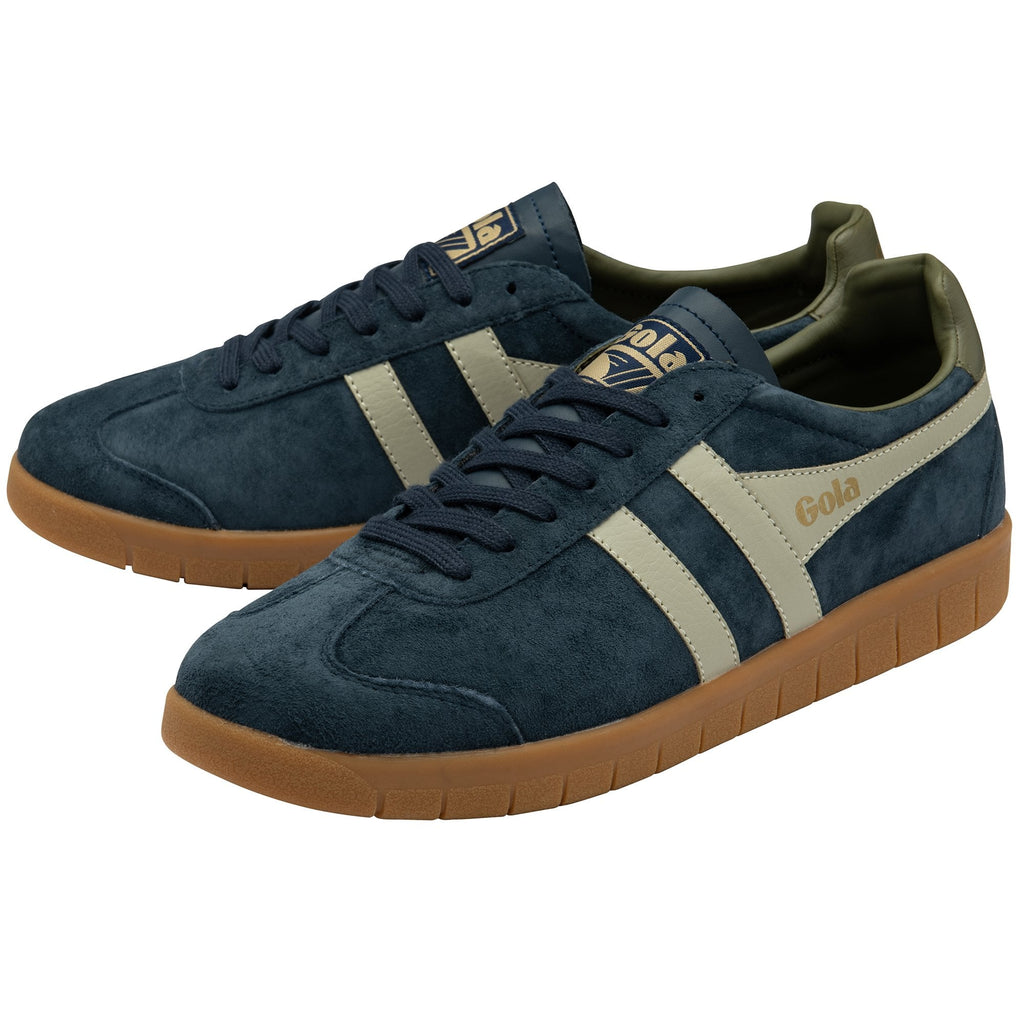 A pair of navy suede Gola sneakers with gum soles and tan accents.