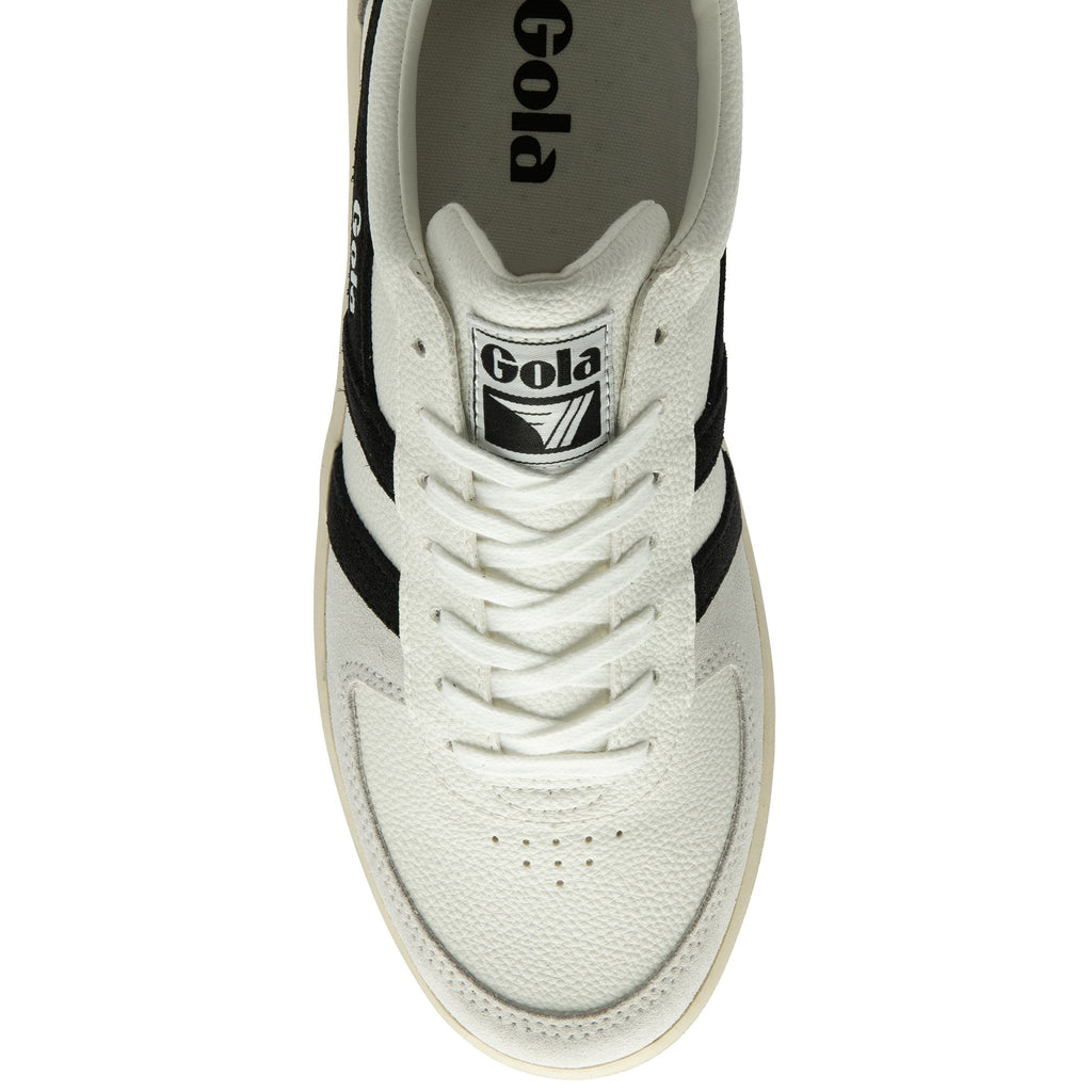 A top-down view of a white Gola sneaker with black stripes.