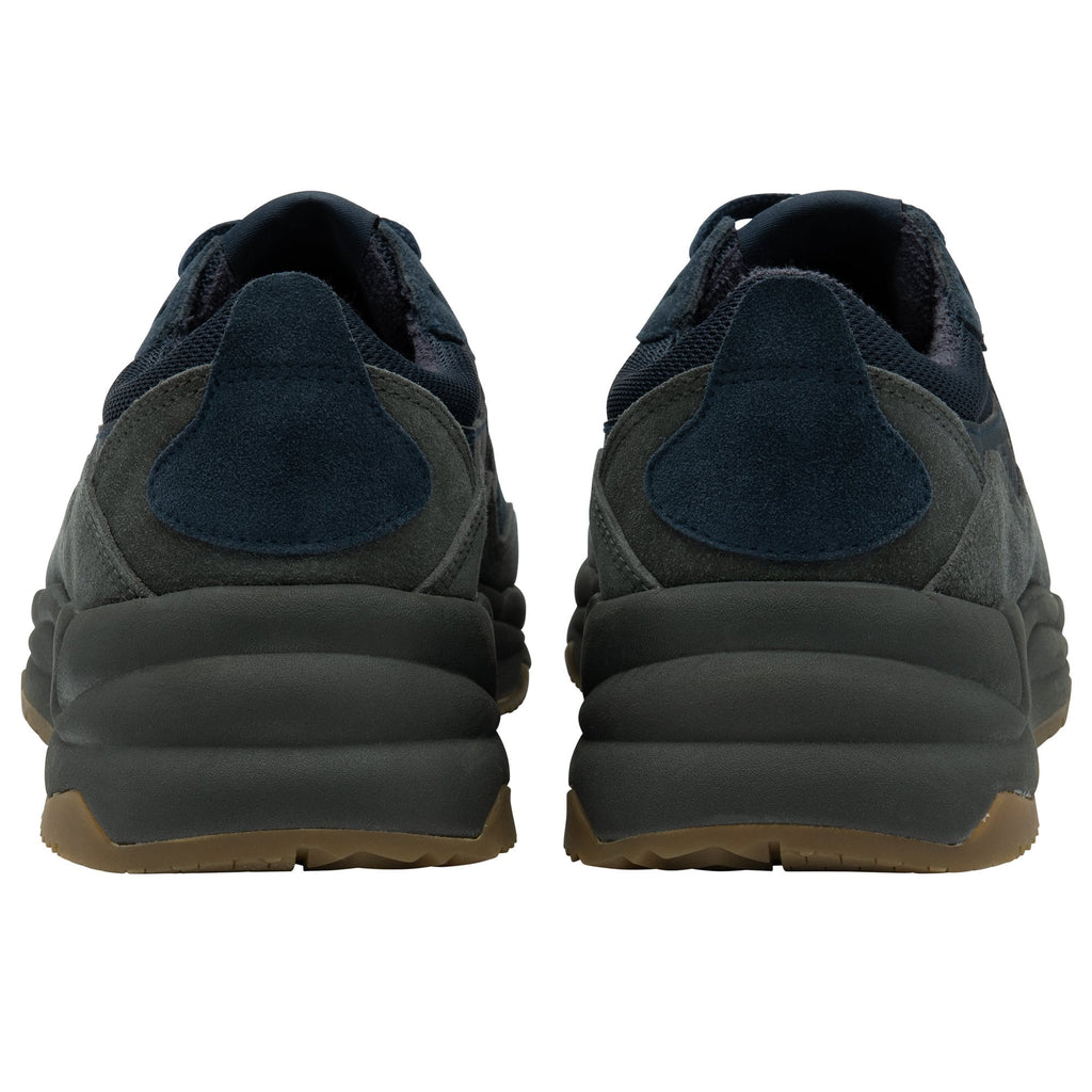 The back view of a pair of Gola men's navy and dark gray sneakers with brown soles.