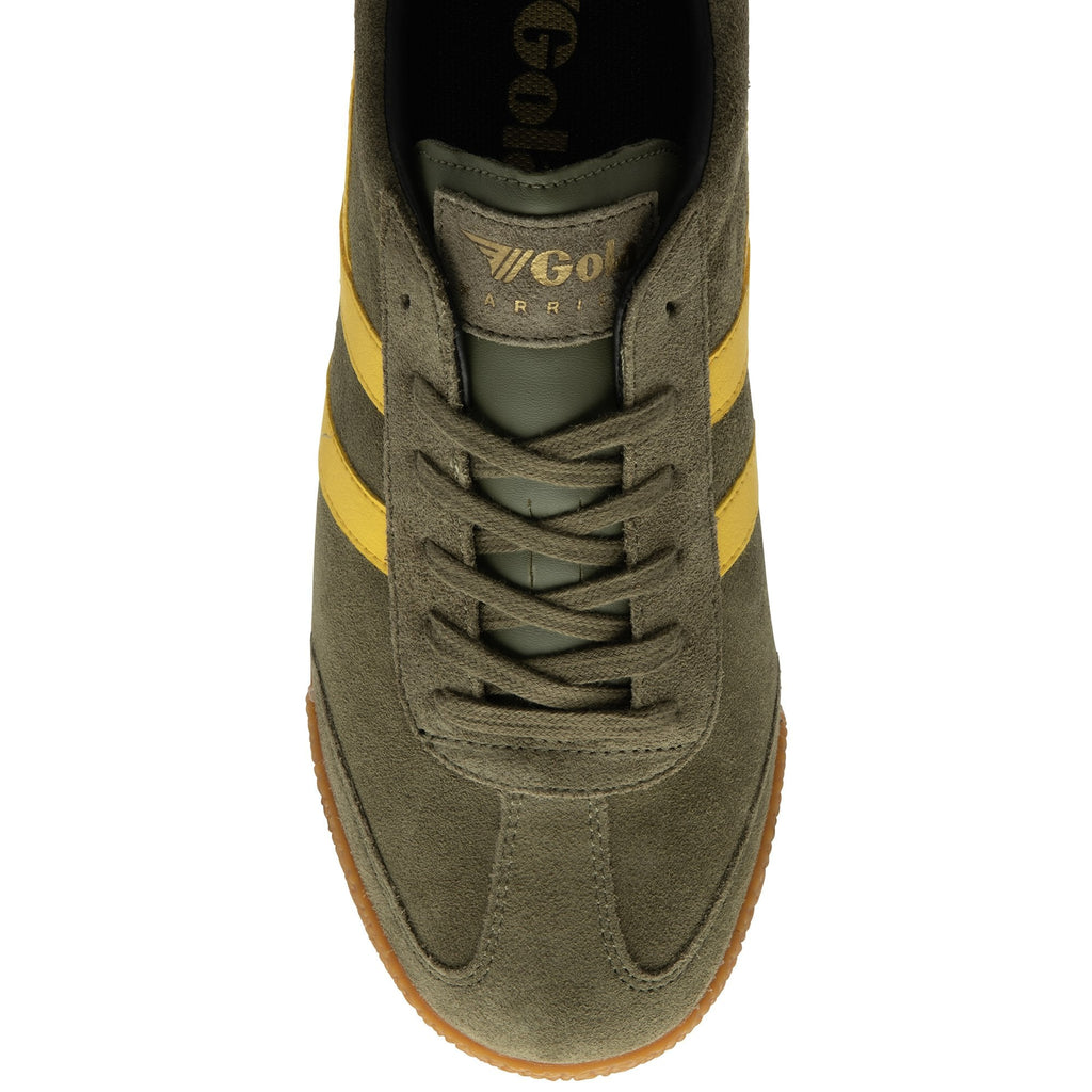 Close up of a Gola Harrier trainer in khaki green suede with yellow side stripes and a gum sole