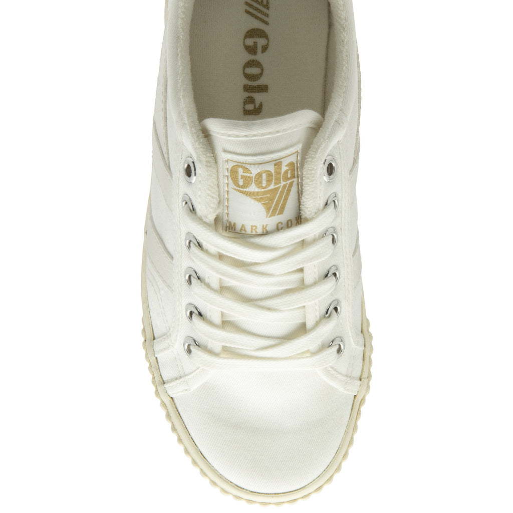 The top-down view of a white canvas sneaker with cream laces and gold Gola logo.
