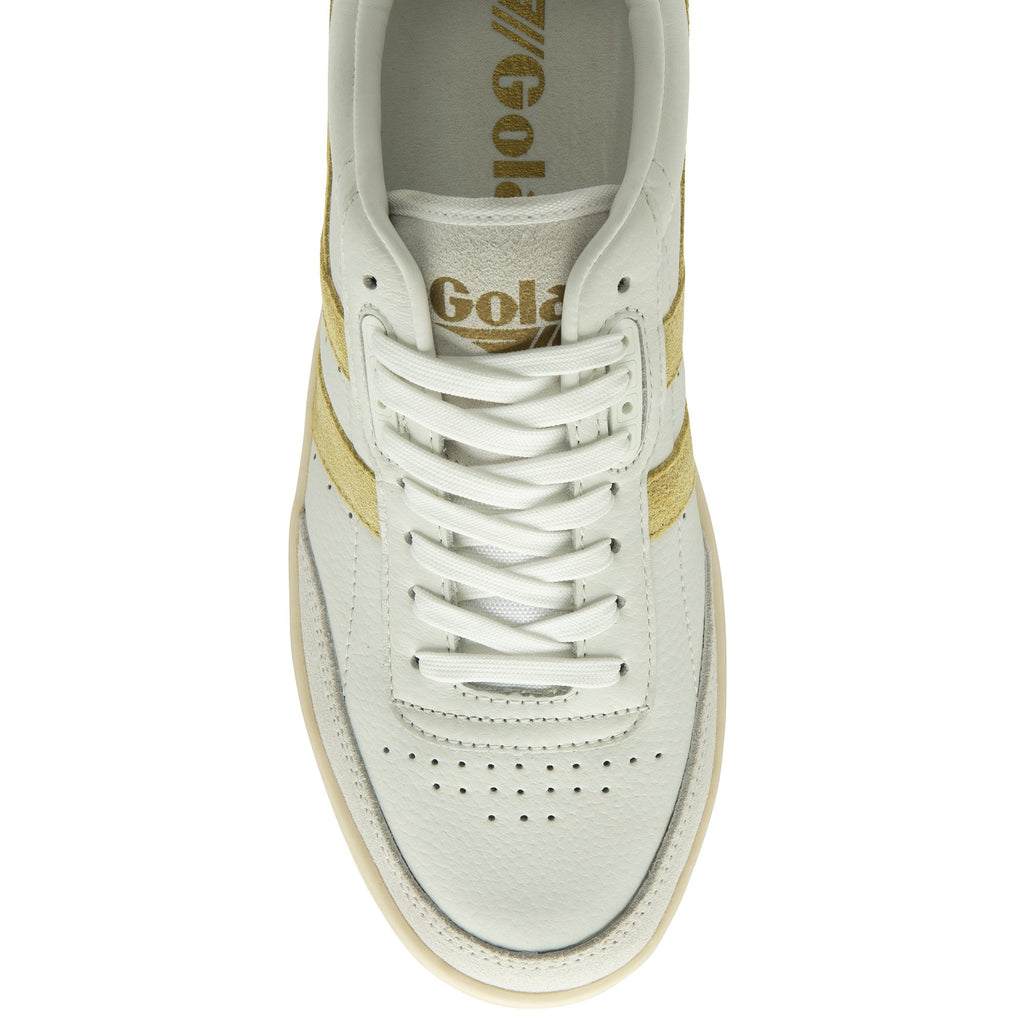 Top-down view of a single Gola women's trainer, in off-white with tan stripes.