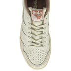 The top-down view of a cream and beige Gola sneaker with a peachy pink tongue on a white background.