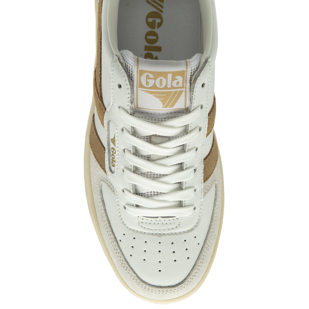 Top down view of a white and gold Gola sneaker.