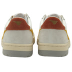 The back view of a pair of white and gold Gola sneakers with orange heel accents.