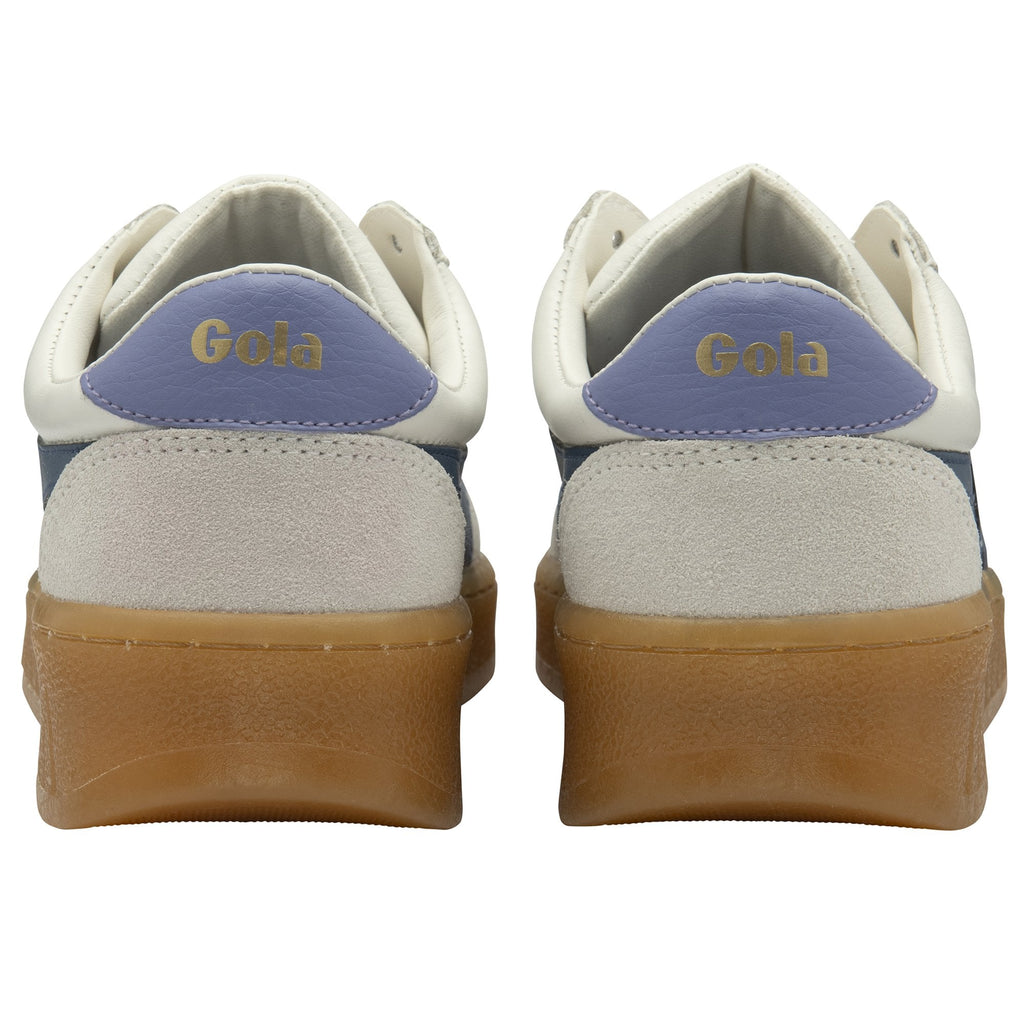 The back view of a pair of white Gola sneakers with light blue heel accents.